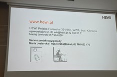 Na zdjęciu ekran z wyświetloną prezentacją. Na slajdzie widoczne napisy podające dane kontaktowe do firmy. Czarne napisy na białym tle.